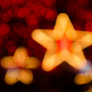 Blurred gold and red star-shaped lights creating a festive holiday atmosphere.