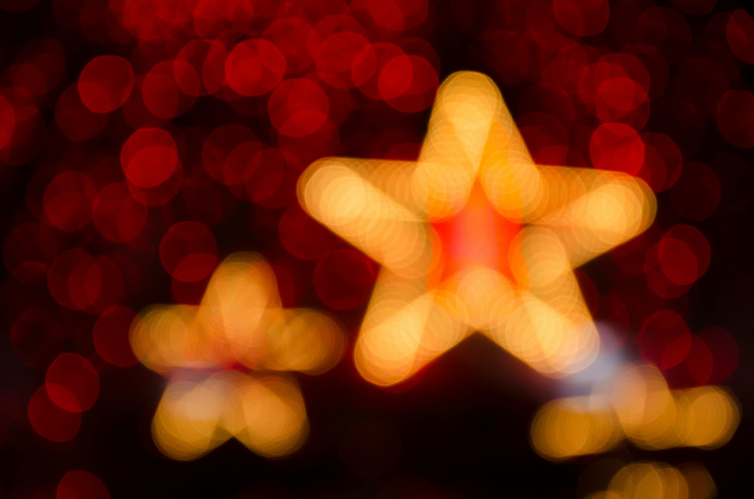 Blurred gold and red star-shaped lights creating a festive holiday atmosphere.